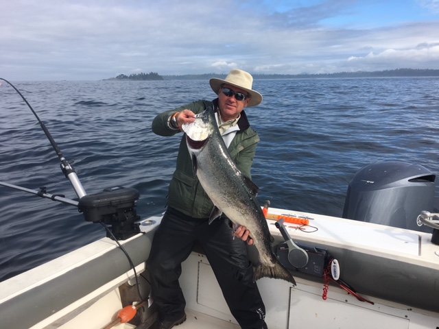 Graham from Vancouver shows his Chinook Salmon landed on surfline of Barkley Sound. This Chinook salmon was landed using a small Coho Killer spoon