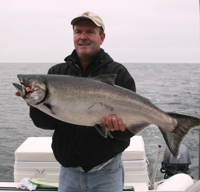 Ken from Kentucky fishing with Slivers Charters Salmon Sport Fishing guides John and Doug and landed this Salmon close to the Barkley Sound Surf line