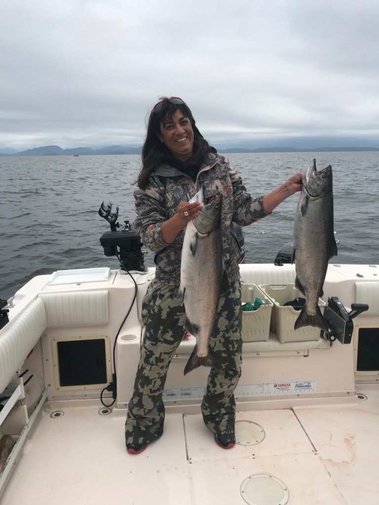 Amberlee shows two salmon she landed using anchovy close to Gilbraltor in Barkley Sound